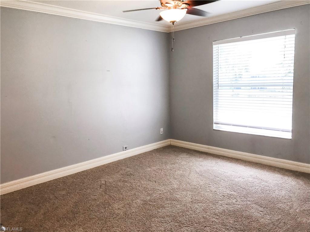 157 Wading Bird Circle, Unit K205 Naples, FL 34110 - Photo 12 of 22 an empty room with a window