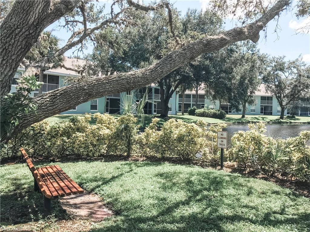 157 Wading Bird Circle, Unit K205 Naples, FL 34110 - Photo 16 of 22 a front view of a house with garden