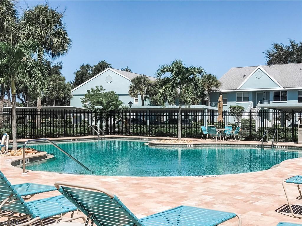157 Wading Bird Circle, Unit K205 Naples, FL 34110 - Photo 17 of 22 a view of a house with a swimming pool