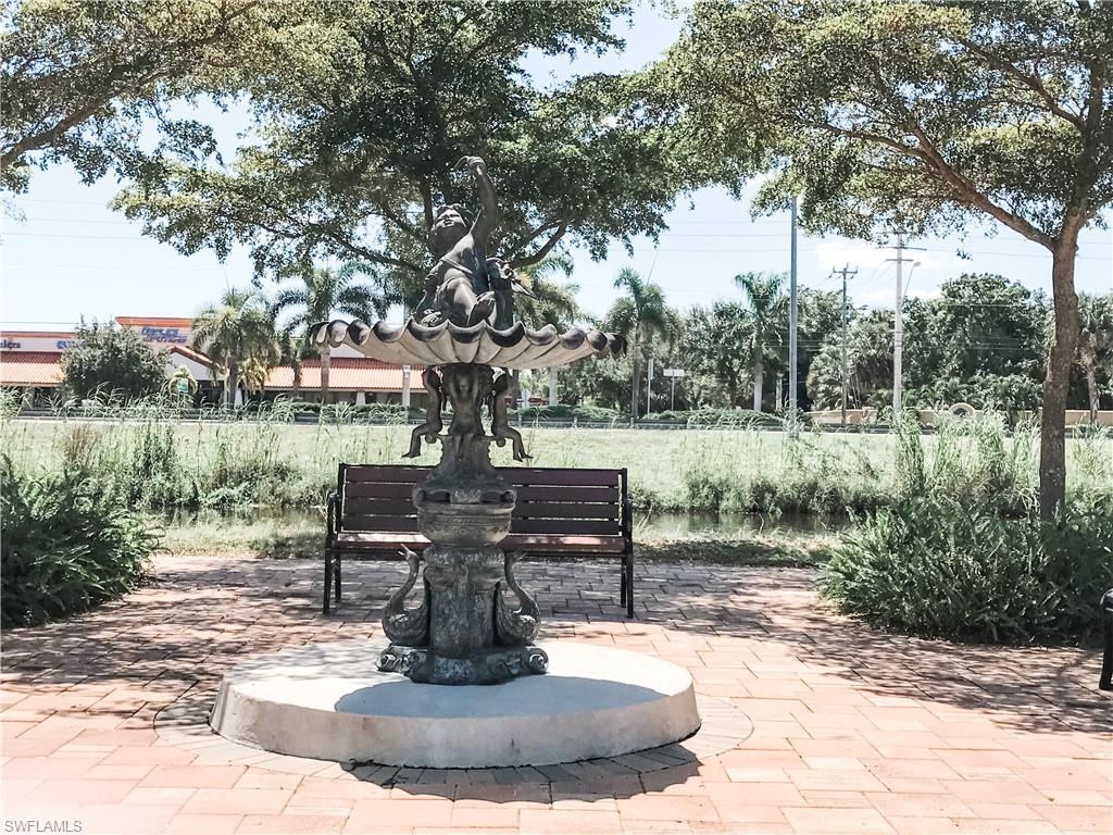 157 Wading Bird Circle, Unit K205 Naples, FL 34110 - Photo 18 of 22 a view of a fountain in the yard with a fountain