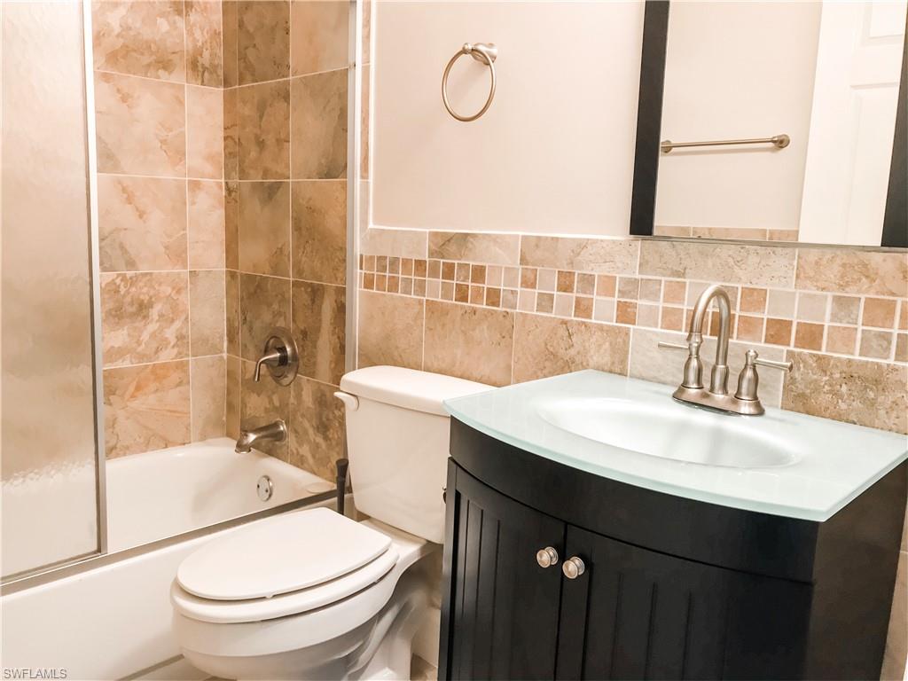 157 Wading Bird Circle, Unit K205 Naples, FL 34110 - Photo 6 of 22 a bathroom with a sink toilet vanity and shower
