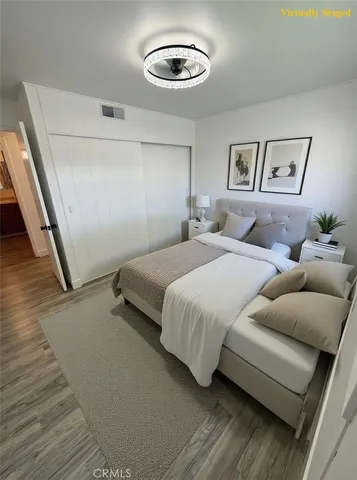 a bedroom with a bed and a painting on the wall