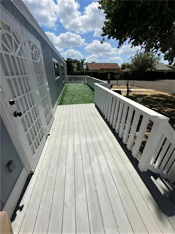 a view of balcony with wooden floor and fence