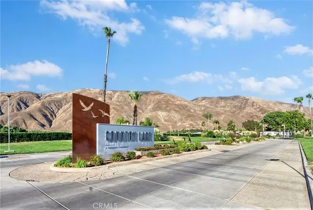 a sign board with buildings in the background