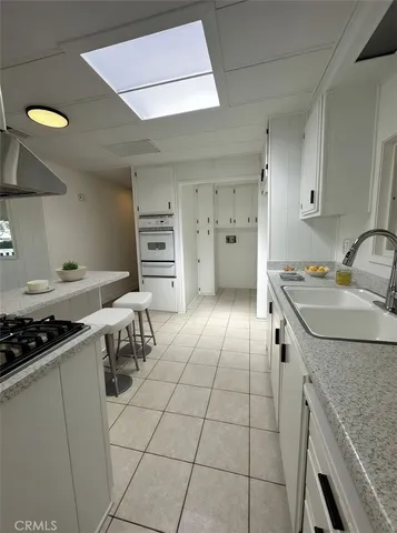 a kitchen with a sink and a stove top oven