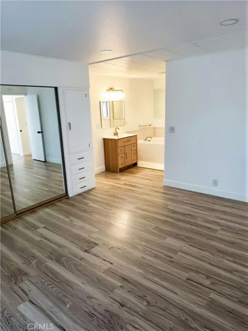 a view of a room with wooden floor and cabinet