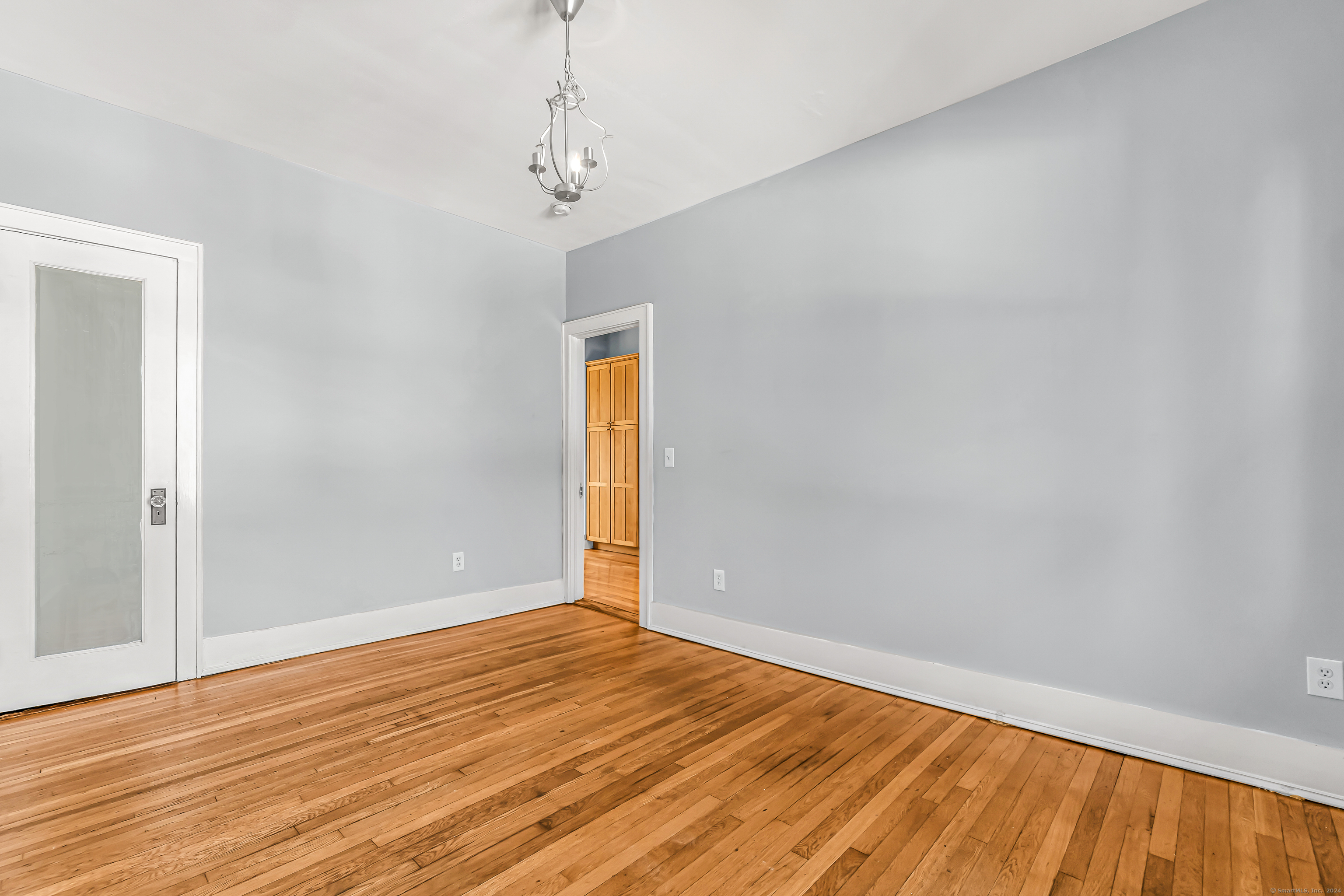 2679 Fairfield Avenue, Unit 2 Bridgeport, CT 06605 - Photo 11 of 22 a view of empty room with wooden floor and fan