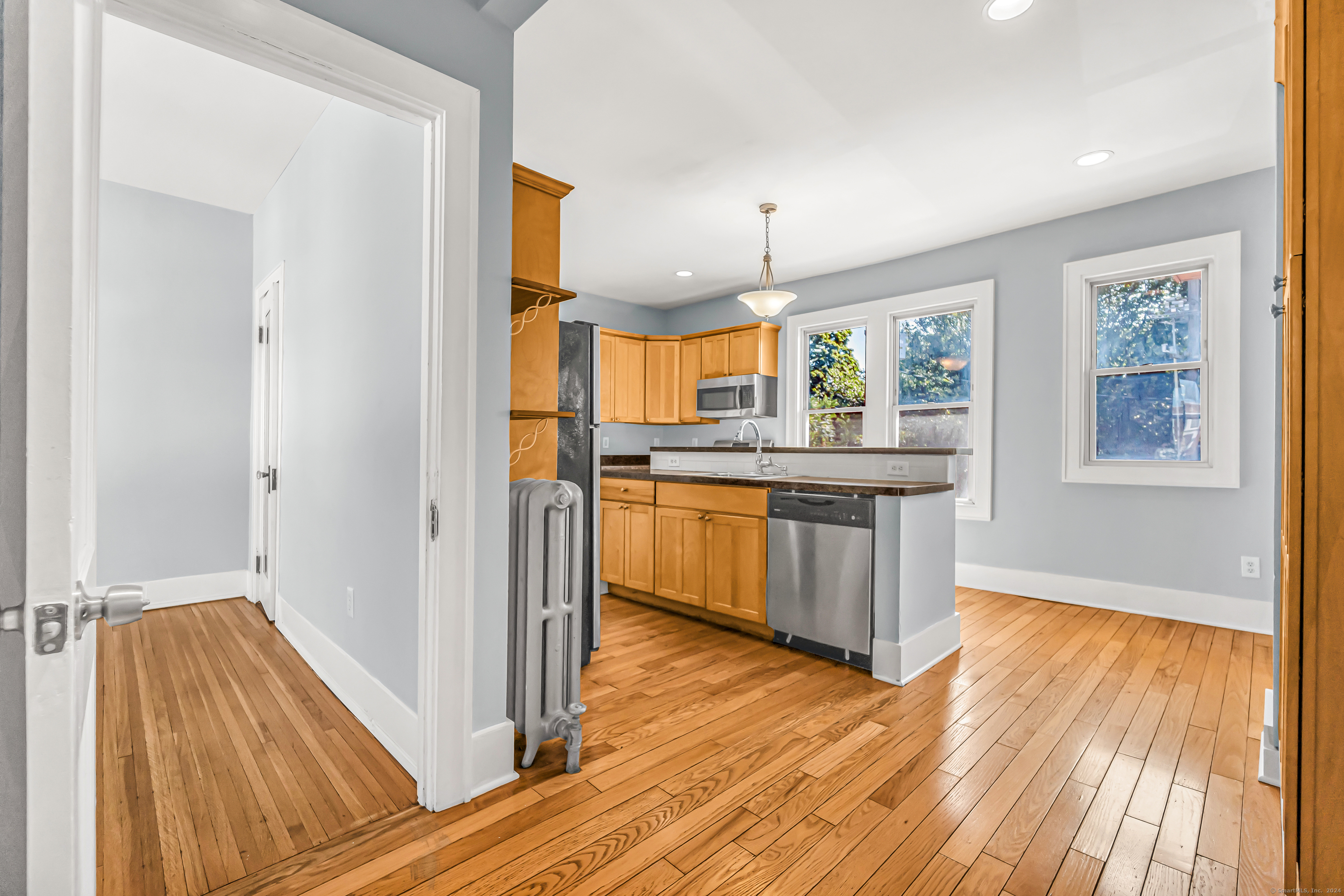 2679 Fairfield Avenue, Unit 2 Bridgeport, CT 06605 - Photo 4 of 22 a kitchen with stainless steel appliances granite countertop wooden floors and sink