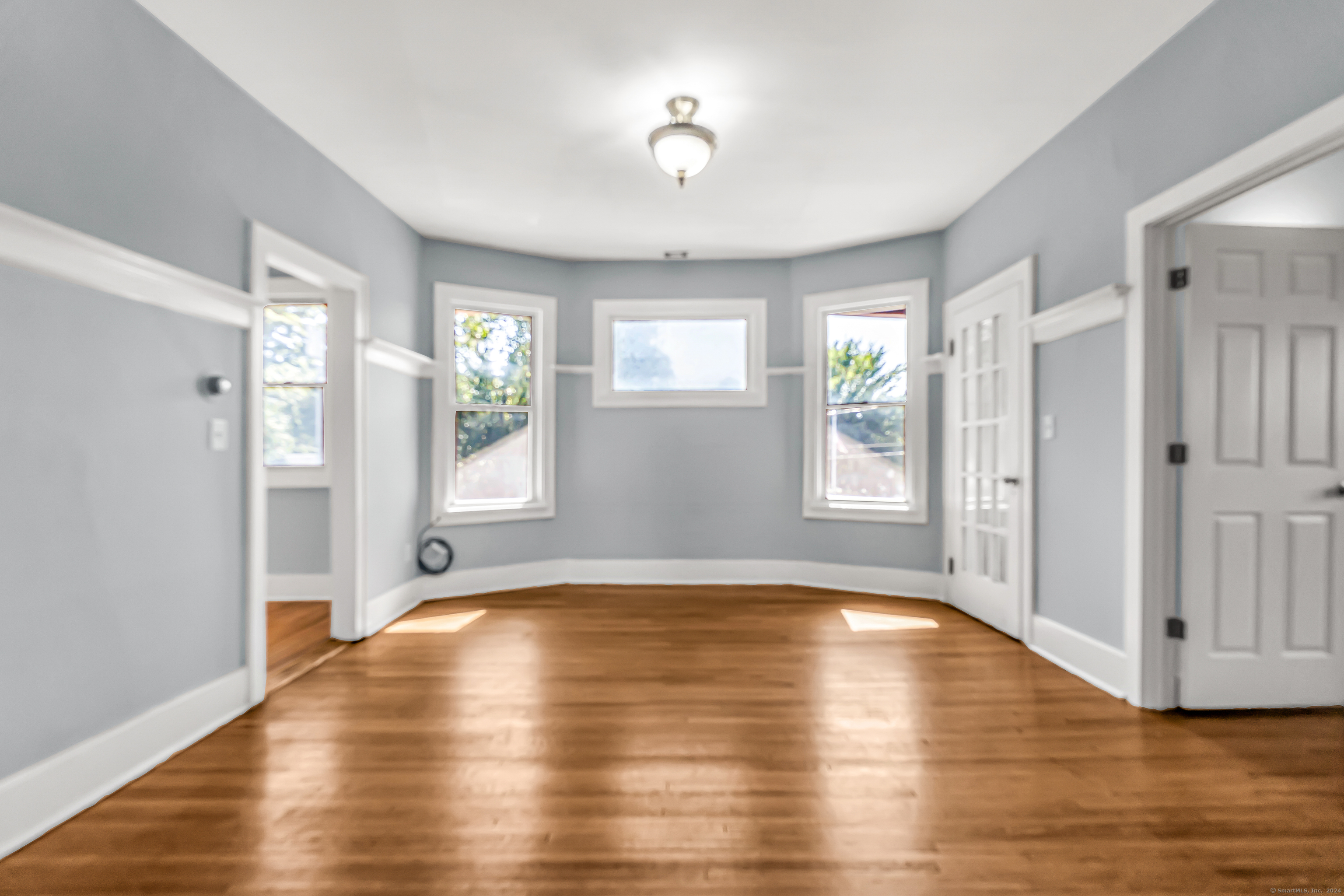 2679 Fairfield Avenue, Unit 2 Bridgeport, CT 06605 - Photo 5 of 22 a view of an empty room with window and wooden floor