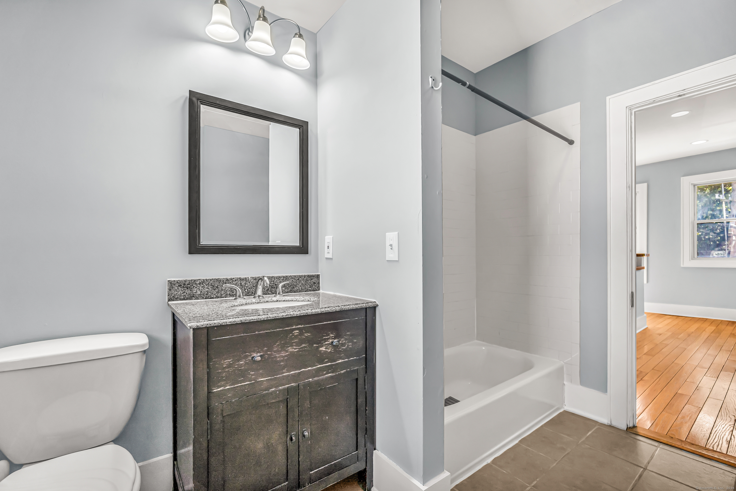 2679 Fairfield Avenue, Unit 2 Bridgeport, CT 06605 - Photo 6 of 22 a bathroom with a granite countertop sink toilet and shower