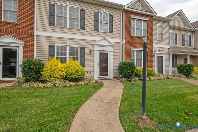 a front view of a house with garden and porch