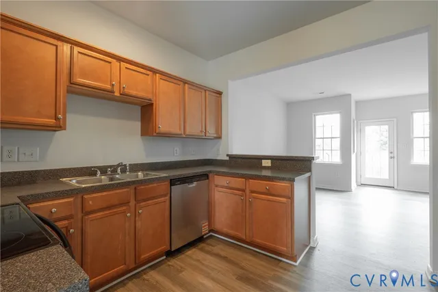a kitchen with stainless steel appliances granite countertop a sink stove and cabinets