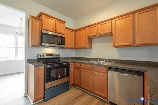 a kitchen with stainless steel appliances granite countertop a stove a microwave and a sink