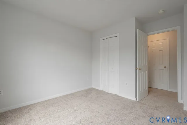a view of an empty room and closet area