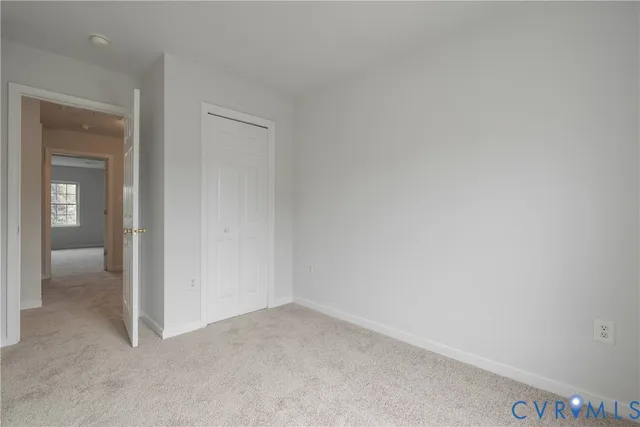 a view of an empty room and closet