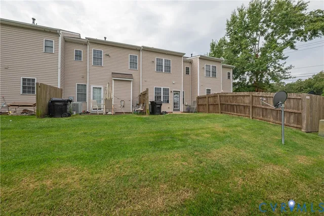 a view of a house with a yard and sitting area