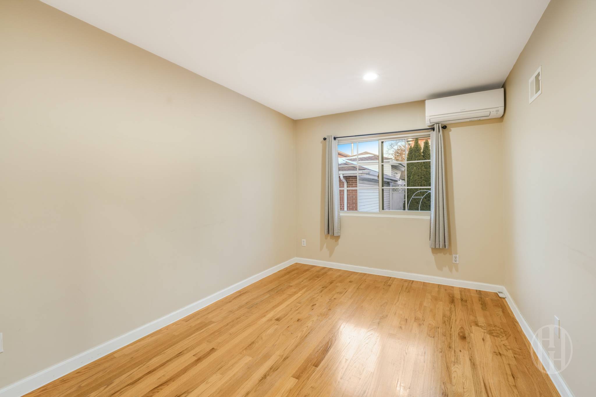 88-10 70th Road, Unit 1 Queens, NY 11375 - Photo 12 of 28 wooden floor in an empty room with a window