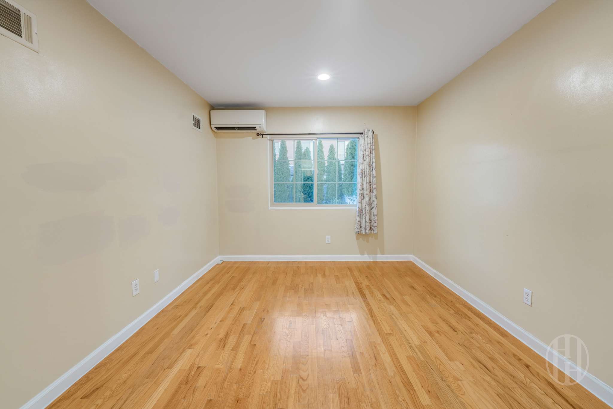 88-10 70th Road, Unit 1 Queens, NY 11375 - Photo 16 of 28 an empty room with wooden floor and windows