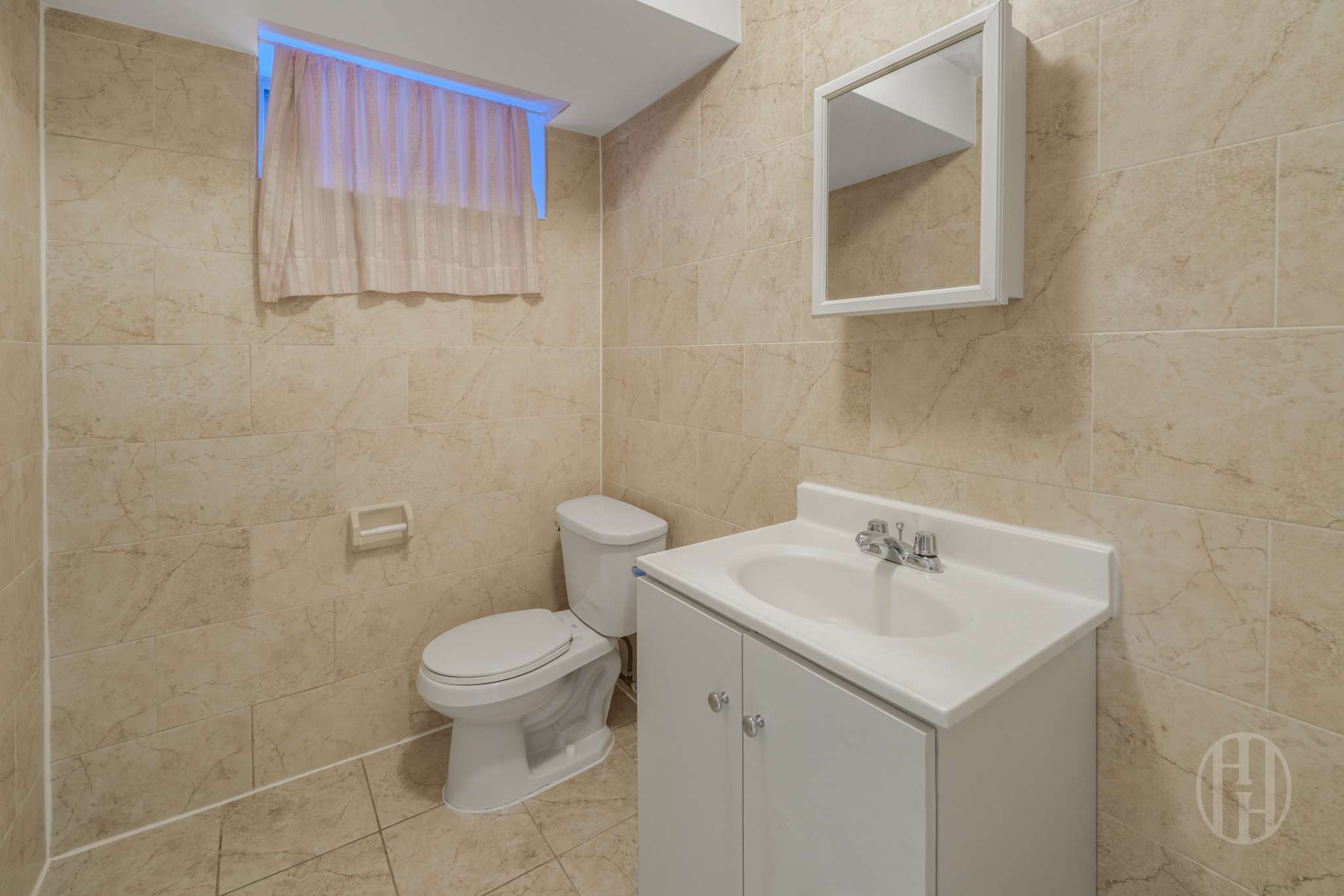 88-10 70th Road, Unit 1 Queens, NY 11375 - Photo 19 of 28 a bathroom with a sink a toilet and a mirror