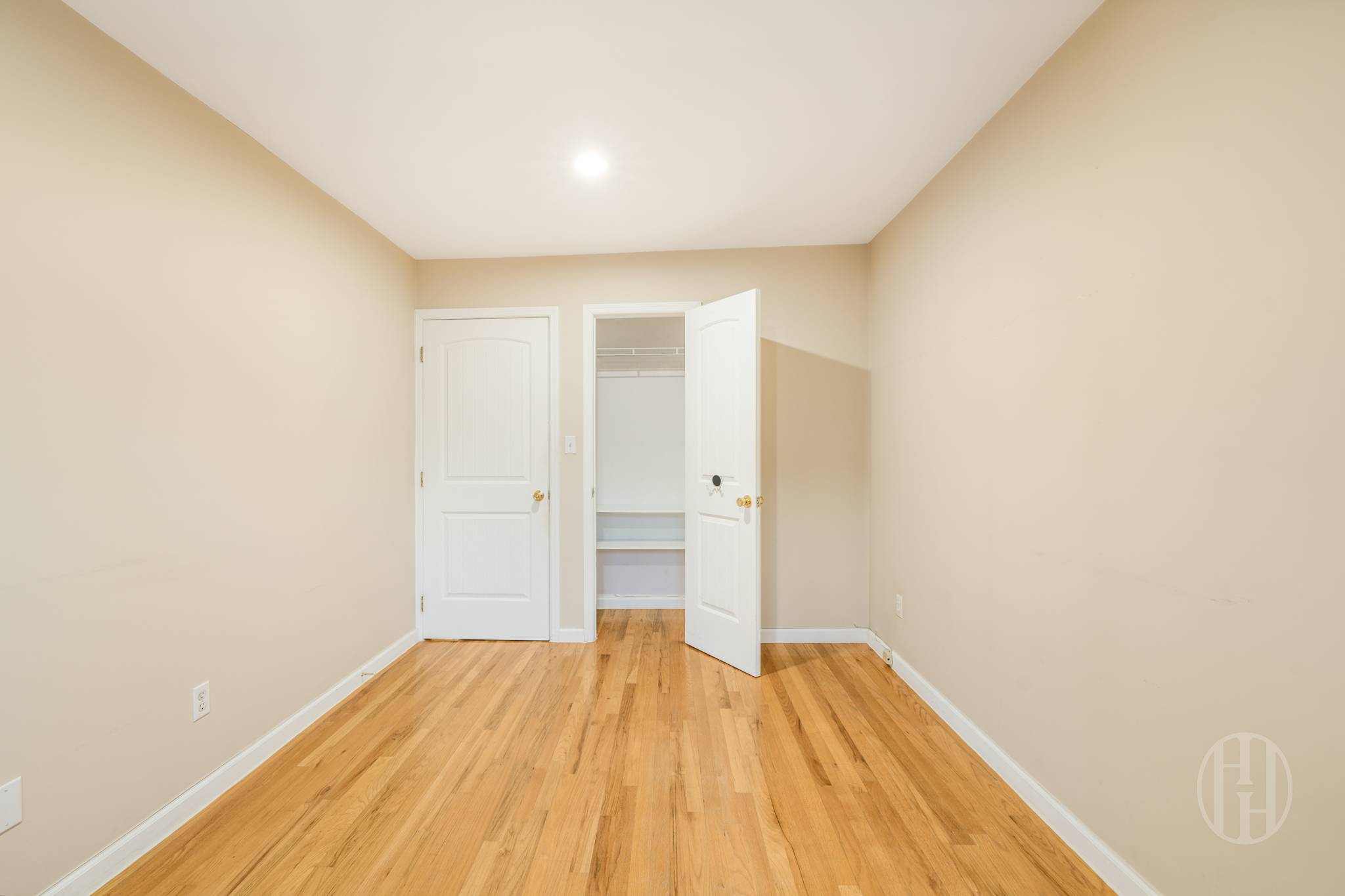 88-10 70th Road, Unit 1 Queens, NY 11375 - Photo 7 of 28 a view of a room with wooden floor and white walls