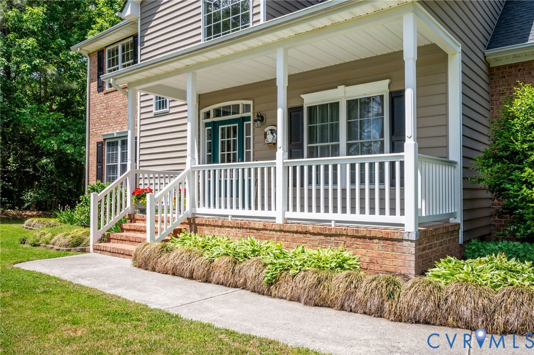 17170 Templeton Road Disputanta, VA 23842 - Photo 3 of 27 a front view of a house with a garden