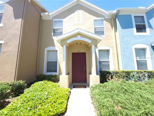 a view of a brick house with a large windows