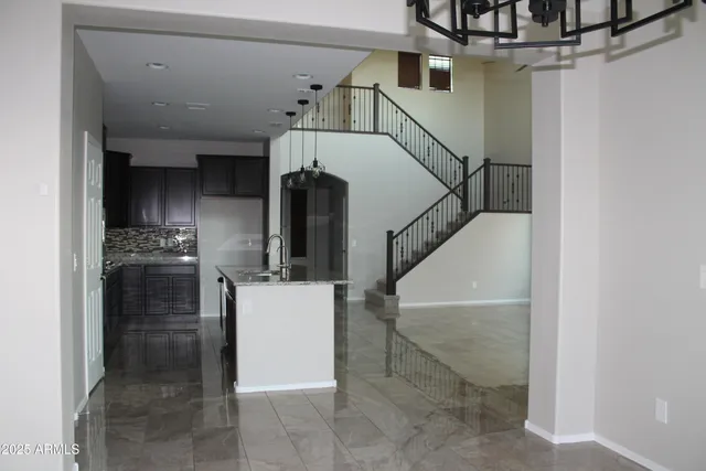 a kitchen with kitchen island a counter top space stainless steel appliances and cabinets