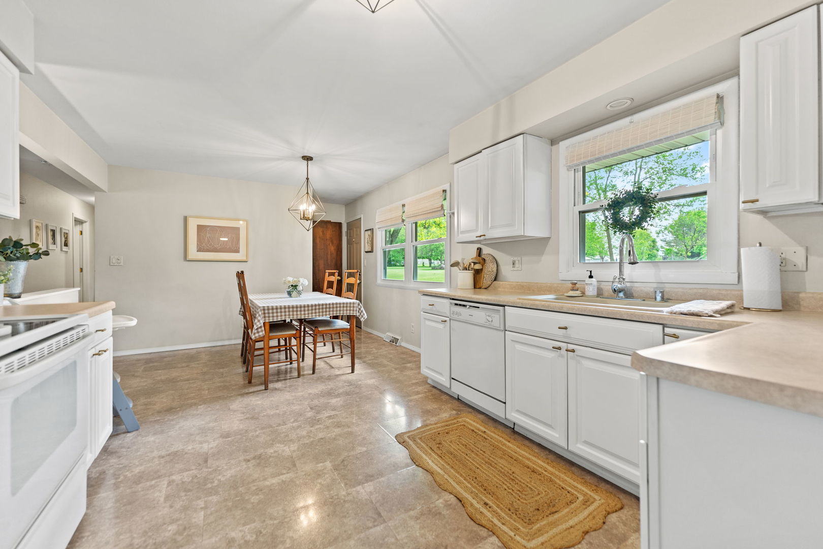 6507 Barkridge Road Roscoe, IL 61073 - Photo 8 of 30 a kitchen with sink cabinets and window