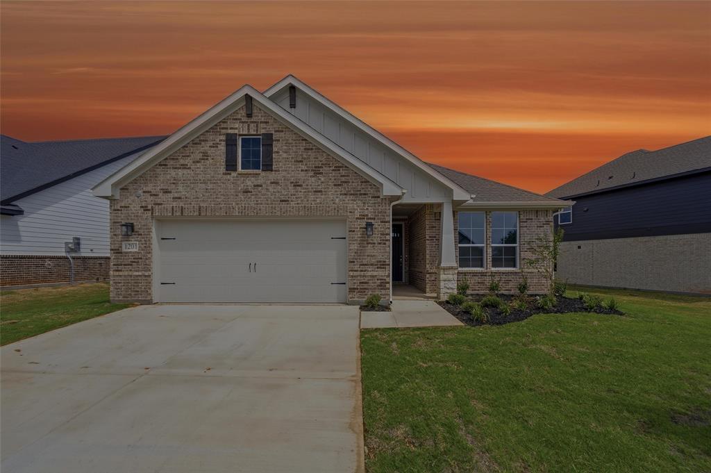 1201 Colca Drive Springtown, TX 76082 - Photo 1 of 32 Brick exterior facade with stone accents, attached two-car garage, concrete driveway, and front landscaping