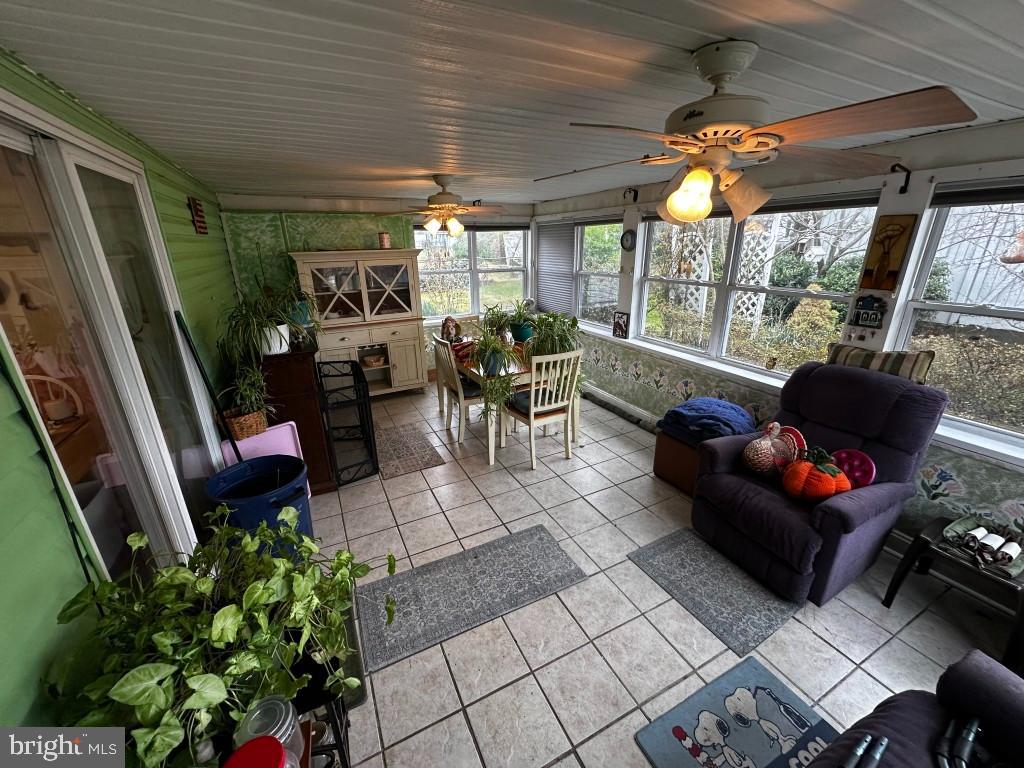 44 Midway Lane Bellmawr, NJ 08031 - Photo 12 of 17 a living room with patio furniture and a potted plant