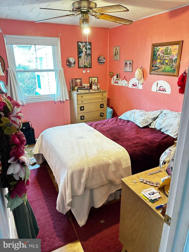 44 Midway Lane Bellmawr, NJ 08031 - Photo 15 of 17 a bedroom with a bed and wooden floor