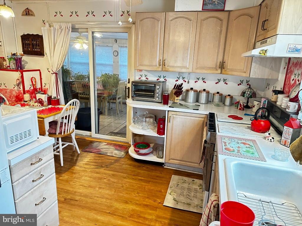 44 Midway Lane Bellmawr, NJ 08031 - Photo 6 of 17 a kitchen with stainless steel appliances granite countertop a stove and white cabinets