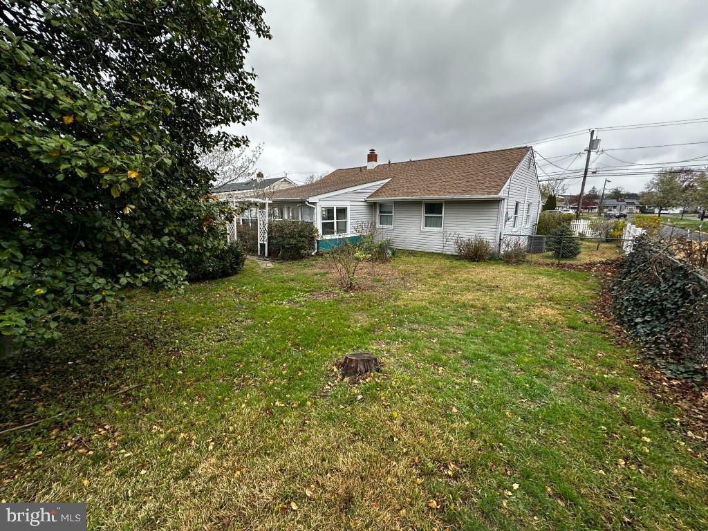 44 Midway Lane Bellmawr, NJ 08031 - Photo 10 of 17 a view of a house next to a big yard and large trees
