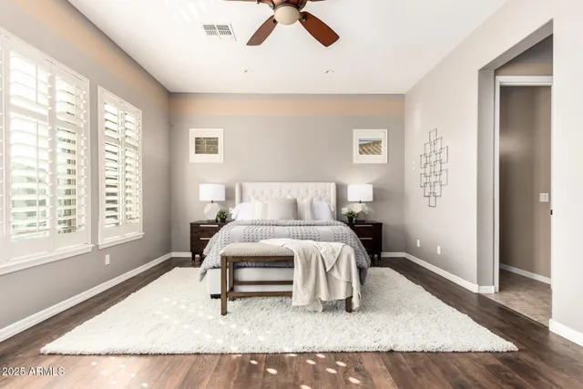 a bedroom with a large bed and a large window