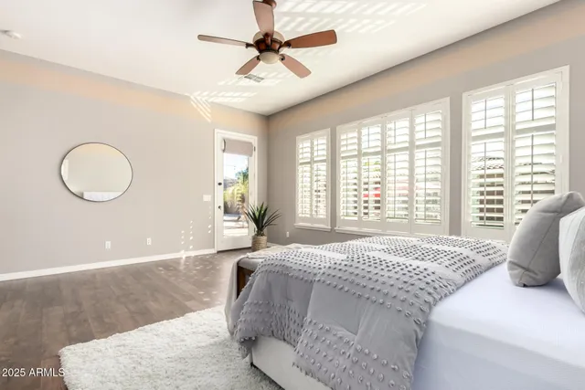a spacious bathroom with a granite countertop sink a mirror and a bathtub
