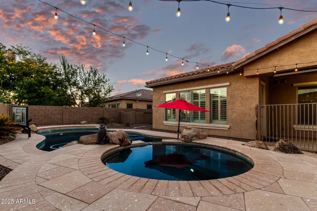a swimming pool with outdoor seating