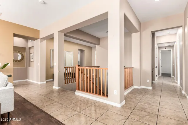 a view of a hallway with wooden floor and a living room