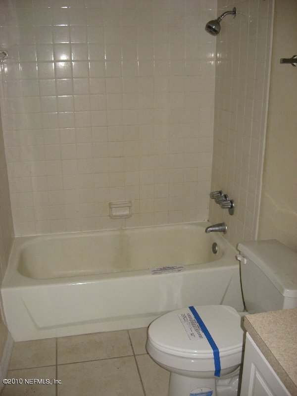 355 Monument Road, Unit 17 D2 Jacksonville, FL 32225 - Photo 7 of 10 a bathroom with a shower and a toilet
