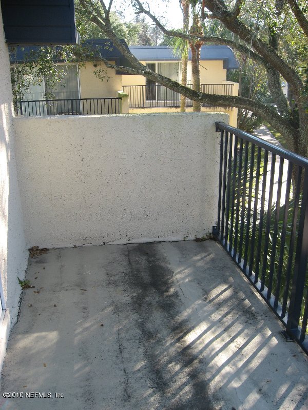 355 Monument Road, Unit 17 D2 Jacksonville, FL 32225 - Photo 10 of 10 a view of a house with a wooden bench