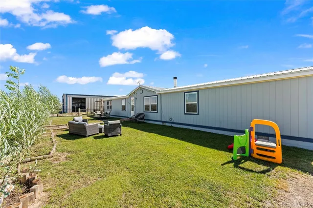 a view of a house with swimming pool and a yard