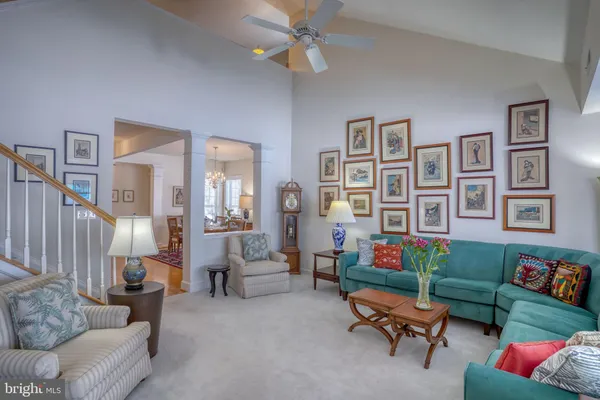 a living room with furniture and a floor to ceiling window