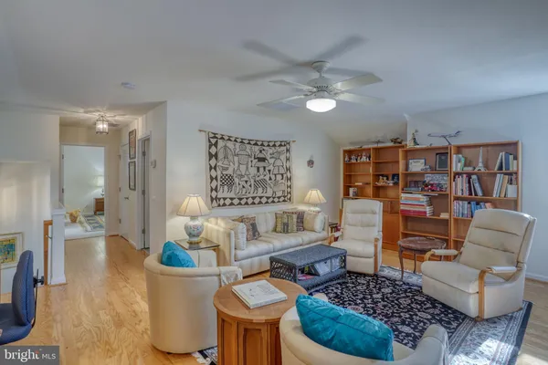 a living room with furniture a flat screen tv and kitchen view