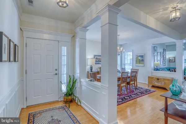 a living room with furniture a chandelier and a rug