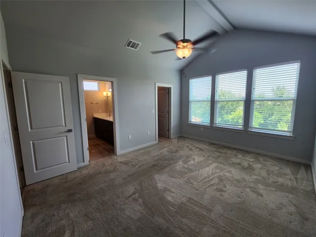a view of a livingroom with a ceiling fan and window