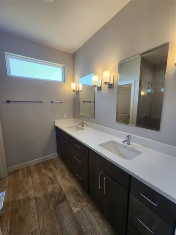 a bathroom with a double vanity sink and mirror
