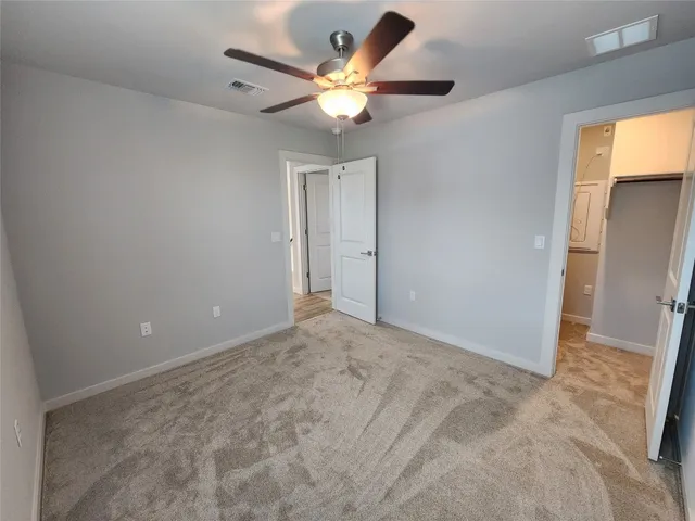 a view of walk in closet with empty racks