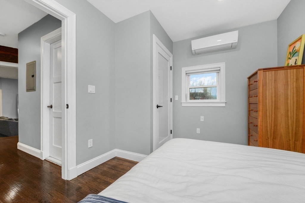 1880 Beacon Street, Unit 6 Brookline, MA 02445 - Photo 14 of 18 a bedroom with a bed and wooden floor