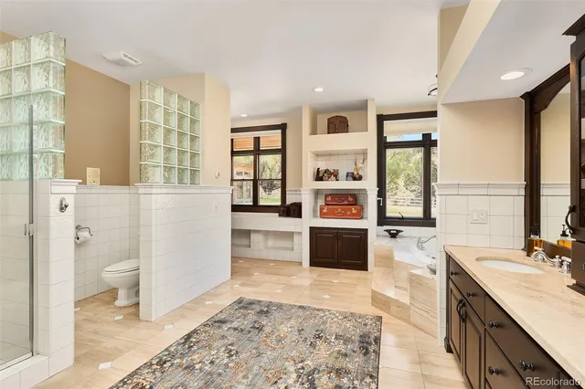 a spacious bathroom with a tub sink and a toilet