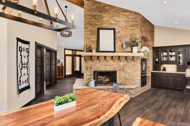 a dining room with furniture and large windows