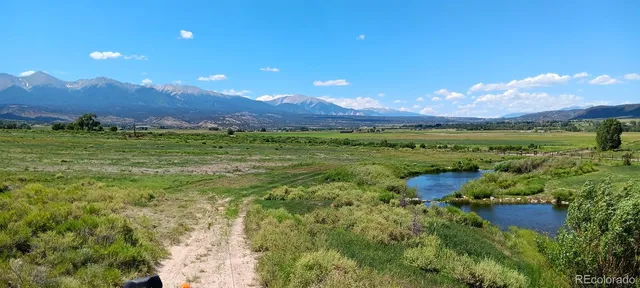 a view of a big house with a big yard and potted plants